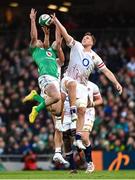18 March 2023; Hugo Keenan of Ireland catches a high ball ahead of Henry Slade and Alex Dombrandt of England during the Guinness Six Nations Rugby Championship match between Ireland and England at Aviva Stadium in Dublin. Photo by Ramsey Cardy/Sportsfile