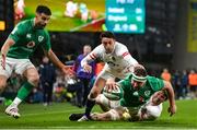 18 March 2023; Rob Herring of Ireland dives over to score his side's fourth try despite the tackle of Alex Mitchell, bottom, and Ben Curry during the Guinness Six Nations Rugby Championship match between Ireland and England at the Aviva Stadium in Dublin. Photo by Seb Daly/Sportsfile