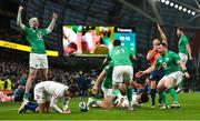 18 March 2023; Ireland players Mack Hansen, left, and Conor Murray, 21, and Cian Healy, right, celebrate their side's fourth try scored by Rob Herring, bottom,during the Guinness Six Nations Rugby Championship match between Ireland and England at the Aviva Stadium in Dublin. Photo by Seb Daly/Sportsfile