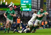 18 March 2023; Jack Conan of Ireland is tackled by David Ribbans and Jack van Poortvliet of England as he offloads to teammate Dan Sheehan, who went on to score their side's third try, during the Guinness Six Nations Rugby Championship match between Ireland and England at the Aviva Stadium in Dublin. Photo by Seb Daly/Sportsfile