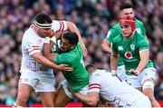 18 March 2023; Bundee Aki of Ireland is tackled by Jamie George, left, and Jack Willis of England during the Guinness Six Nations Rugby Championship match between Ireland and England at Aviva Stadium in Dublin. Photo by Ramsey Cardy/Sportsfile