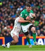 18 March 2023; Peter O'Mahony of Ireland is tackled by Henry Slade of England during the Guinness Six Nations Rugby Championship match between Ireland and England at Aviva Stadium in Dublin. Photo by Ramsey Cardy/Sportsfile