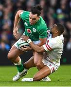 18 March 2023; James Lowe of Ireland is tackled by Anthony Watson of England during the Guinness Six Nations Rugby Championship match between Ireland and England at Aviva Stadium in Dublin. Photo by Ramsey Cardy/Sportsfile