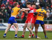 19 March 2023; Pearse Lillis, left, and Ikem Ugweru of Clare tussles with Derry players Eoin McEvoy and Conor Doherty before the Allianz Football League Division 2 match between Derry and Clare at Derry GAA Centre of Excellence in Owenbeg, Derry. Photo by Ben McShane/Sportsfile