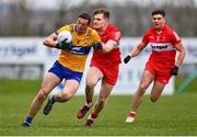19 March 2023; Cathal O'Connor of Clare is tackled by Ethan Doherty of Derry during the Allianz Football League Division 2 match between Derry and Clare at Derry GAA Centre of Excellence in Owenbeg, Derry. Photo by Ben McShane/Sportsfile
