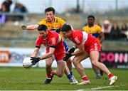 19 March 2023; Derry players Christopher McKaigue, centre, and Conor Doherty in action against Keelan Sexton of Clare during the Allianz Football League Division 2 match between Derry and Clare at Derry GAA Centre of Excellence in Owenbeg, Derry. Photo by Ben McShane/Sportsfile