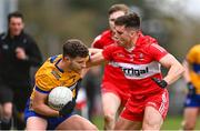 19 March 2023; Ronan Lanigan of Clare is tackled by Conor Doherty of Derry during the Allianz Football League Division 2 match between Derry and Clare at Derry GAA Centre of Excellence in Owenbeg, Derry. Photo by Ben McShane/Sportsfile