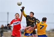 19 March 2023; Derry goalkeeper Odhran Lynch and Brendan Rogers of Derry punch the ball clear from Clare players Cathal O'Connor and Alan Sweeney, 7, during the Allianz Football League Division 2 match between Derry and Clare at Derry GAA Centre of Excellence in Owenbeg, Derry. Photo by Ben McShane/Sportsfile