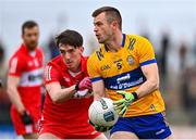 19 March 2023; Ciarán Russell of Clare in action against Paul Cassidy of Derry during the Allianz Football League Division 2 match between Derry and Clare at Derry GAA Centre of Excellence in Owenbeg, Derry. Photo by Ben McShane/Sportsfile