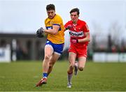 19 March 2023; Jamie Malone of Clare in action against Paul Cassidy of Derry during the Allianz Football League Division 2 match between Derry and Clare at Derry GAA Centre of Excellence in Owenbeg, Derry. Photo by Ben McShane/Sportsfile