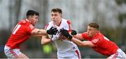 19 March 2023; Luke Fahy of Cork in action against Liam Jackson, left, and Ryan Burns of Louth during the Allianz Football League Division 2 match between Louth and Cork at Páirc Mhuire in Ardee, Louth. Photo by Stephen Marken/Sportsfile