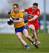 19 March 2023; Pearse Lillis of Clare in action against Gareth McKinless of Derry during the Allianz Football League Division 2 match between Derry and Clare at Derry GAA Centre of Excellence in Owenbeg, Derry. Photo by Ben McShane/Sportsfile