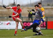 19 March 2023; Naill Loughlin of Derry has a shot on goal saved by Clare goalkeeper Stephen Ryan during the Allianz Football League Division 2 match between Derry and Clare at Derry GAA Centre of Excellence in Owenbeg, Derry. Photo by Ben McShane/Sportsfile