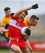 19 March 2023; Shane McGuigan of Derry is fouled by Ciarán Russell of Clare during the Allianz Football League Division 2 match between Derry and Clare at Derry GAA Centre of Excellence in Owenbeg, Derry. Photo by Ben McShane/Sportsfile