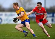 19 March 2023; Pearse Lillis of Clare evades the tackle of Gareth McKinless of Derry during the Allianz Football League Division 2 match between Derry and Clare at Derry GAA Centre of Excellence in Owenbeg, Derry. Photo by Ben McShane/Sportsfile