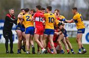 19 March 2023; Clare and Derry players, including Derry manager Rory Gallagher, left, tussle during the Allianz Football League Division 2 match between Derry and Clare at Derry GAA Centre of Excellence in Owenbeg, Derry. Photo by Ben McShane/Sportsfile
