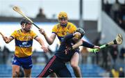 19 March 2023; Cork goalkeeper Ger Collins is tackled by Clare players David Fitzgerald, r?ight, and David Reidy during the Allianz Hurling League Division 1 Group A match between Clare and Cork at Cusack Park in Ennis, Clare. Photo by John Sheridan/Sportsfile
