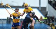 19 March 2023; Cork goalkeeper Ger Collins is tackled by Clare players David Fitzgerald, r?ight, and David Reidy during the Allianz Hurling League Division 1 Group A match between Clare and Cork at Cusack Park in Ennis, Clare. Photo by John Sheridan/Sportsfile