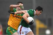 19 March 2023; Tommy Conroy of Mayo in action against Caolan Ward of Donegal during the Allianz Football League Division 1 match between Donegal and Mayo at MacCumhaill Park in Ballybofey, Donegal. Photo by Ramsey Cardy/Sportsfile