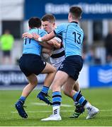 20 March 2023; Paul Dunne of Belvedere College is tackled by Eoin Loo, left, and Matthew Haugh of St Michael's College during the Bank of Ireland Leinster Rugby Schools Junior Cup semi-final replay match between Belvedere College and St Michael’s College at Energia Park in Dublin. Photo by Ben McShane/Sportsfile