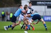 20 March 2023; David Barr of Belvedere College is tackled by Matthew Haugh, left, and Myles Berman of St Michael's College during the Bank of Ireland Leinster Rugby Schools Junior Cup semi-final replay match between Belvedere College and St Michael’s College at Energia Park in Dublin. Photo by Ben McShane/Sportsfile