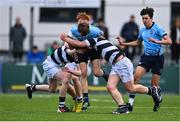 20 March 2023; Josh Divilly of St Michael's College is tackled by Jonny Garrihy, left, and Billy Ball of Belvedere College during the Bank of Ireland Leinster Rugby Schools Junior Cup semi-final replay match between Belvedere College and St Michael’s College at Energia Park in Dublin. Photo by Ben McShane/Sportsfile