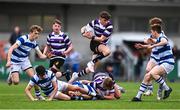 20 March 2023; Niall Fallon of Terenure College jumps over tackled players as he makes a break during the Bank of Ireland Leinster Rugby Schools Junior Cup semi-final replay match between Terenure College and Blackrock College at Energia Park in Dublin. Photo by Ben McShane/Sportsfile