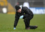 19 March 2023; Donegal team doctor Dr Kevin Moran slips in wet conditions during the Allianz Football League Division 1 match between Donegal and Mayo at MacCumhaill Park in Ballybofey, Donegal. Photo by Ramsey Cardy/Sportsfile
