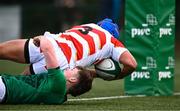22 March 2023; Tsubasa Moriyama of Japan dives over to score his side's second try despite the tackle of Stephen Kiely of Ireland during the Under-19 Rugby International match between Ireland and Japan at Lakelands Park in Dublin. Photo by Harry Murphy/Sportsfile