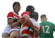 22 March 2023; Yoshitaka Yazaki of Japan, 15, celebrates with teammates Jingo Takenoshita, centre, and Joji Takaki after scoring his side's third try during the Under-19 Rugby International match between Ireland and Japan at Lakelands Park in Dublin. Photo by Harry Murphy/Sportsfile