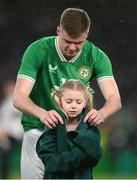 22 March 2023; Evan Ferguson of Republic of Ireland gives his walkout jacket to a mascots before the international friendly match between Republic of Ireland and Latvia at Aviva Stadium in Dublin. Photo by Stephen McCarthy/Sportsfile