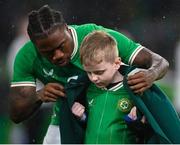 22 March 2023; Michael Obafemi of Republic of Ireland puts his walkout jacket on a mascot before the international friendly match between Republic of Ireland and Latvia at Aviva Stadium in Dublin. Photo by Stephen McCarthy/Sportsfile