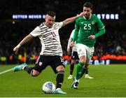 22 March 2023; Roberts Savalnieks of Latvia in action against Mikey Johnston of Republic of Ireland during the international friendly match between Republic of Ireland and Latvia at Aviva Stadium in Dublin. Photo by Michael P Ryan/Sportsfile