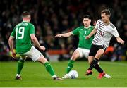 22 March 2023; Janis Ikaunieks of Latvia in action against Callum O’Dowda and Evan Ferguson, left, of Republic of Ireland during the international friendly match between Republic of Ireland and Latvia at Aviva Stadium in Dublin. Photo by Stephen McCarthy/Sportsfile