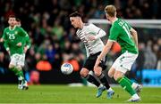 22 March 2023; Dävis Ikaunieks of Latvia in action against Nathan Collins of Republic of Ireland during the international friendly match between Republic of Ireland and Latvia at Aviva Stadium in Dublin. Photo by Brendan Moran/Sportsfile