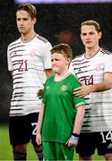 22 March 2023; Latvia's Andrejs Ciganiks tries to keep his player mascot warm before the international friendly match between Republic of Ireland and Latvia at Aviva Stadium in Dublin. Photo by Stephen McCarthy/Sportsfile