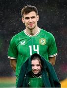 22 March 2023; A young mascot wearing the anthem jacket of Jayson Molumby of Republic of Ireland during a shower of rain before the international friendly match between Republic of Ireland and Latvia at Aviva Stadium in Dublin. Photo by Stephen McCarthy/Sportsfile