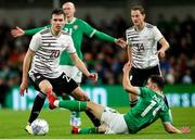 22 March 2023; Roberts Uldrikis of Latvia is tackled by Jayson Molumby of Republic of Ireland during the international friendly match between Republic of Ireland and Latvia at Aviva Stadium in Dublin. Photo by Michael P Ryan/Sportsfile
