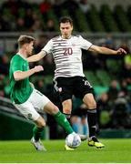 22 March 2023; Roberts Uldrikis of Latvia in action against Nathan Collins of Republic of Ireland during the international friendly match between Republic of Ireland and Latvia at Aviva Stadium in Dublin. Photo by Michael P Ryan/Sportsfile