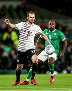 22 March 2023; Arturs Zjuzins of Latvia in action against Michael Obafemi of Republic of Ireland during the international friendly match between Republic of Ireland and Latvia at Aviva Stadium in Dublin. Photo by Michael P Ryan/Sportsfile
