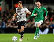 22 March 2023; Vladislavs Sorokins of Latvia in action against Will Smallbone of Republic of Ireland during the international friendly match between Republic of Ireland and Latvia at Aviva Stadium in Dublin. Photo by Michael P Ryan/Sportsfile