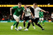 22 March 2023; James McClean of Republic of Ireland in action against Raimonds Krollis of Latvia during the international friendly match between Republic of Ireland and Latvia at Aviva Stadium in Dublin. Photo by Michael P Ryan/Sportsfile