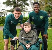 25 March 2023; Jason Knight, left, and Chiedozie Ogbene meet Vincent Lyons, age 12, from Blanchardstown, after a Republic of Ireland training session at the FAI National Training Centre in Abbotstown, Dublin. Photo by Stephen McCarthy/Sportsfile