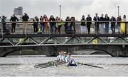 25 March 2023; Spectators watch on as the UCD team, from front to back, Shauna Fitzsimons (Cox), Fintan Earley, Sam Daly, David Somers, Paul Flood, Luke Dunleavy, Mika Ryan, Mikey Campion and David Crooks make their way to winning the Colours Boat Race between UCD and Trinity College on the River Liffey in Dublin. Photo by David Fitzgerald/Sportsfile