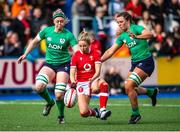 25 March 2023; Hannah Jones of Wales recovers the ball under pressure from Sam Monaghan and Brittany Hogan of Ireland during the TikTok Women's Six Nations Rugby Championship match between Wales and Ireland at Cardiff Arms Park in Cardiff, Wales. Photo by Mark Lewis/Sportsfile