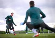 25 March 2023; Evan Ferguson has a shot on goalkeeper Mark Travers during a Republic of Ireland training session at the FAI National Training Centre in Abbotstown, Dublin. Photo by Stephen McCarthy/Sportsfile