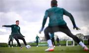 25 March 2023; Evan Ferguson has a shot on goalkeeper Mark Travers during a Republic of Ireland training session at the FAI National Training Centre in Abbotstown, Dublin. Photo by Stephen McCarthy/Sportsfile
