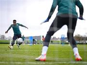 25 March 2023; Chiedozie Ogbene has a shot on goalkeeper Mark Travers during a Republic of Ireland training session at the FAI National Training Centre in Abbotstown, Dublin. Photo by Stephen McCarthy/Sportsfile