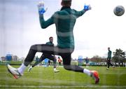 25 March 2023; Chiedozie Ogbene has a shot on goalkeeper Mark Travers during a Republic of Ireland training session at the FAI National Training Centre in Abbotstown, Dublin. Photo by Stephen McCarthy/Sportsfile