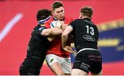 25 March 2023; Jack Crowley of Munster is tackled by Rory Darge and Stafford McDowall of Glasgow Warriors during the United Rugby Championship match between Munster and Glasgow Warriors at Thomond Park in Limerick. Photo by Harry Murphy/Sportsfile